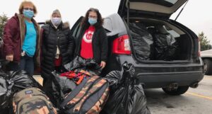 Jessie, Suzi and Cheryl transferring supplies for Malawi